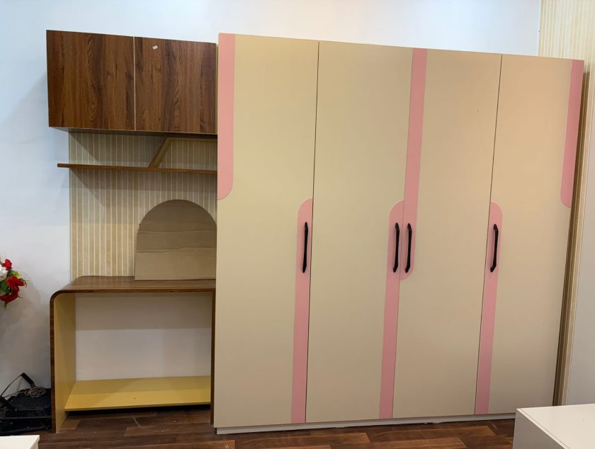Cream and blush four-door wardrobe with curved study desk and arched display niche